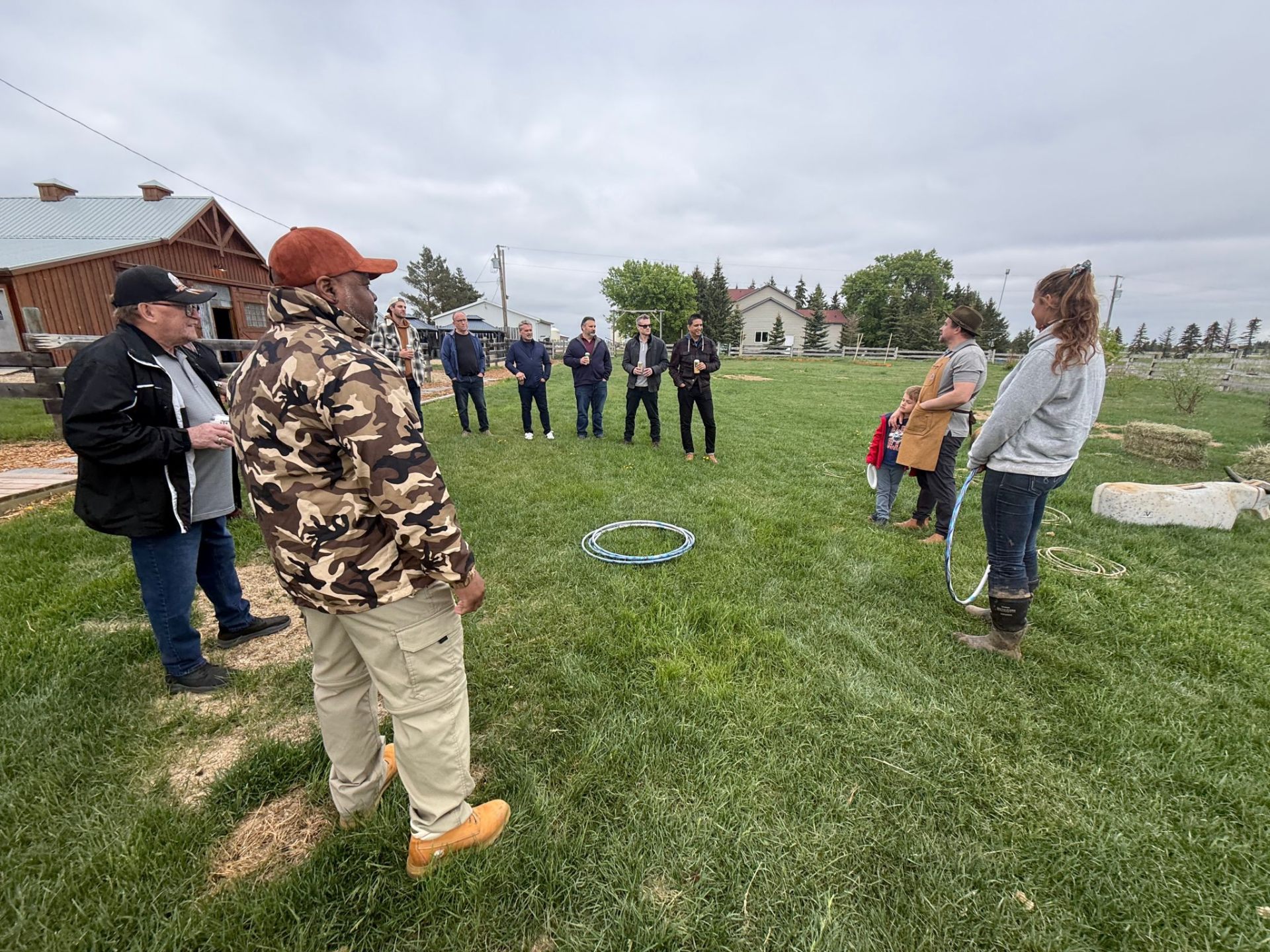 Men gathered in a circle on a Prairie farm